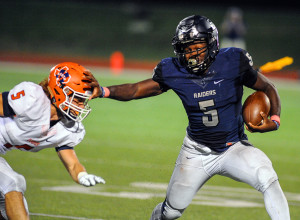 Evan Ghormley/The Wylie News Eno Benjamin stiff-arms a McKinney North defender en route to a 268-yard, five-touchdown rushing performance.