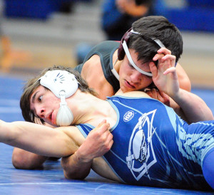 Evan Ghormley/C&SMediaTexas Wylie’s Ryan Rigby, top, defeated Aaron Gassett 12-4 in the 126-pound match.