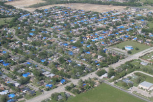 Blue plastic tarps dot neighborhoods, indicating houses that sustained substantial hail damage in a storm that struck April 11 throughout Wylie.